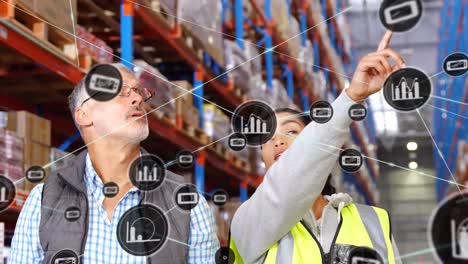Animation-of-digital-icons-on-diverse-male-supervisor-and-female-worker-checking-stock-at-warehouse