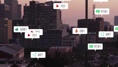 Animation-of-social-media-icons-falling-against-aerial-view-of-cityscape