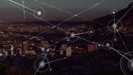 Animation-of-network-of-connections-against-aerial-view-of-cityscape