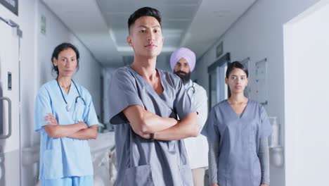 Portrait-of-diverse-doctors-and-nurses-in-corridor-at-hospital,-in-slow-motion