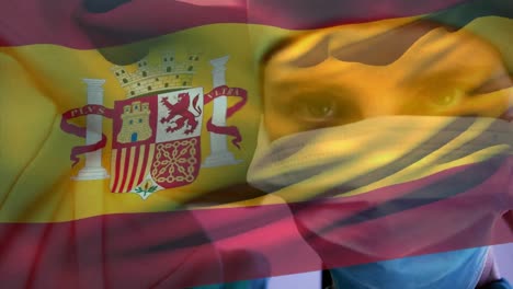 Animation-of-waving-spanish-flag-against-caucasian-female-surgeon-wearing-surgical-mask-at-hospital
