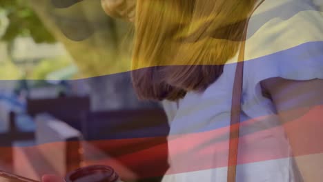 Animation-of-flag-of-colombia-over-diverse-female-friends-using-smartphone