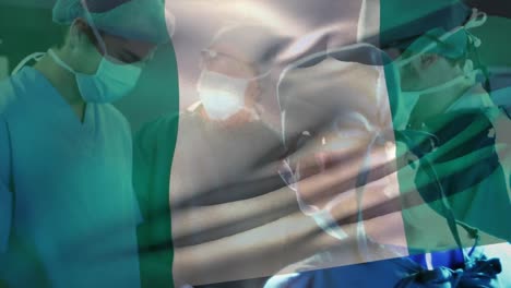 Animación-De-Ondear-La-Bandera-De-Nigeria-Contra-Un-Equipo-De-Cirujanos-Diversos-Que-Realizan-Operaciones-En-El-Hospital