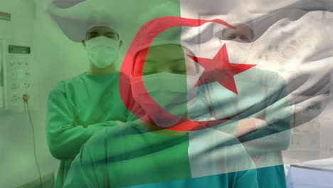 Animation-of-waving-algeria-flag-against-team-of-diverse-surgeons-standing-at-hospital