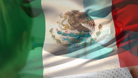 Animation-of-waving-mexico-flag-over-caucasian-male-surgeon-operating-pregnant-woman-during-delivery