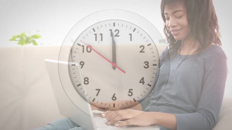 Animation-of-clock-ticking-over-african-american-businesswoman-in-office
