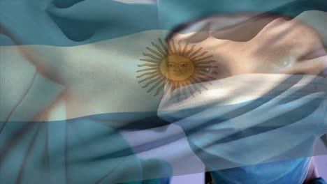 Animation-of-flag-of-argentina-over-caucasian-female-surgeon-with-face-mask