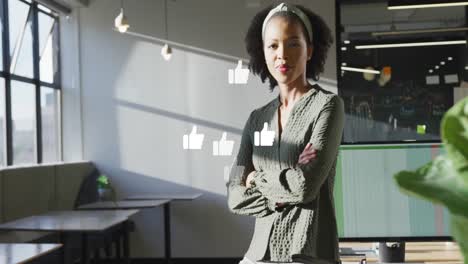 Animation-of-thumbs-up-icons-and-data-processing-over-african-american-businesswoman-in-office