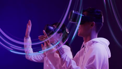 Animation-of-glowing-light-trails-of-data-transfer-and-asian-people-in-vr-headset