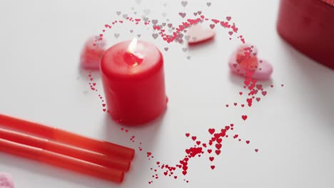 Animation-of-hearts-over-candles-on-white-background