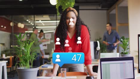 Animation-of-profile-icon-with-increasing-numbers-over-biracial-woman-smiling-at-office