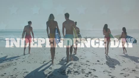 Animation-of-independence-text-over-group-of-diverse-friends-with-surfboards-walking-at-the-beach