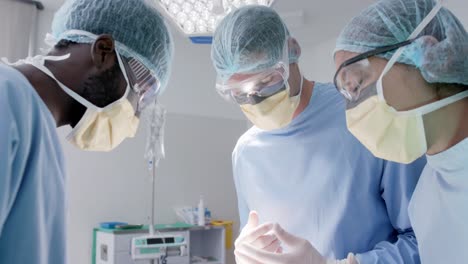 Focused-diverse-male-and-female-surgeons-with-face-masks-talking-in-slow-motion,-unaltered