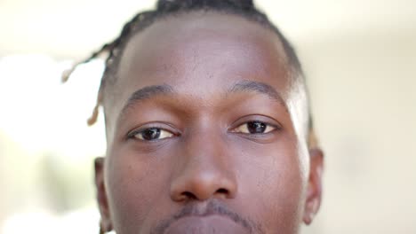 Portrait-close-up-of-happy-african-american-man-short-dreadlocks-smiling,-in-slow-motion