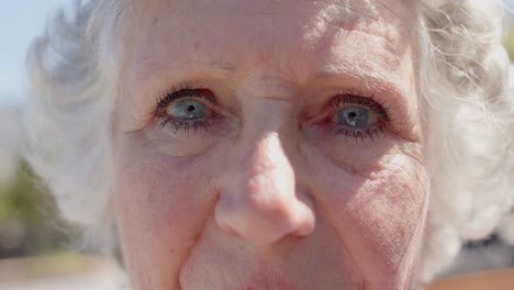 Portrait-close-up-of-happy-senior-caucasian-woman-in-garden,-unaltered,-in-slow-motion