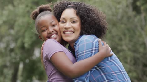 Portrait-of-happy-diverse-mother-with-daughter-embracing-in-slow-motion