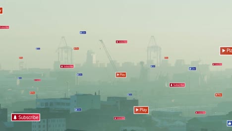 Animation-of-multiple-social-media-icons-floating-against-aerial-view-of-cityscape