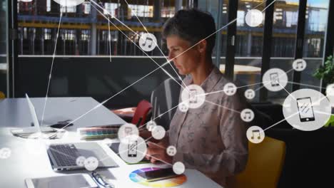 Animation-of-network-of-profile-icons-over-caucasian-businesswoman-using-graphic-tablet-at-office