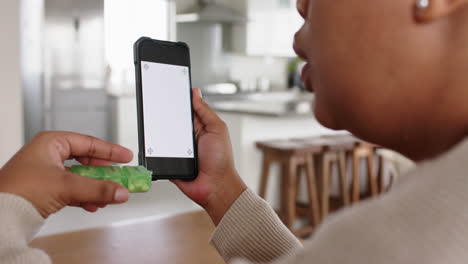 Unaltered-african-american-woman-using-smartphone-with-copy-space-holding-medication,-in-slow-motion