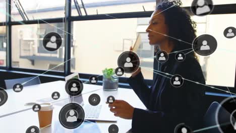 Animation-of-network-of-profiles-over-biracial-businesswoman-talking-on-smartphone-at-office