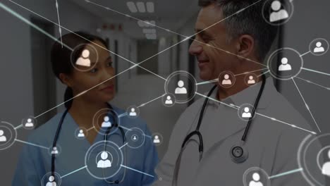 Animation-of-network-of-connections-with-icons-over-diverse-doctors