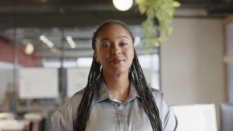 Portrait-of-happy-african-american-casual-businesswoman-smiling-at-office,-slow-motion