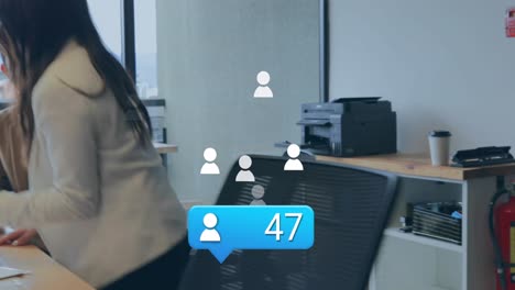 Animation-of-profile-icon-with-increasing-numbers-over-diverse-man-and-woman-discussing-at-office