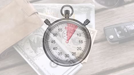 Animation-of-stop-watch-ticking-over-american-dollar-currency-banknotes