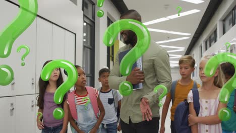 Animation-of-green-question-marks-over-happy-african-american-male-teacher-and-pupils-in-corridor