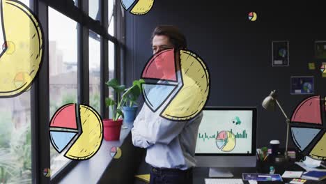 Animation-of-multiple-pie-graph-icons-over-thoughtful-caucasian-man-looking-out-of-window-at-office