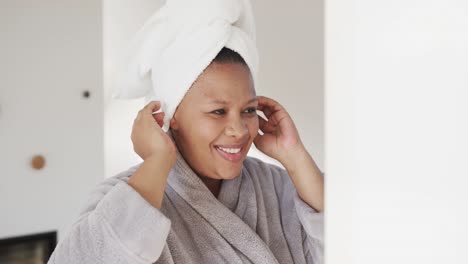 Happy-african-american-plus-size-woman-wearing-towel-on-head,-unaltered,-slow-motion
