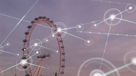 Animation-of-dots-connected-with-lines-over-giant-wheel-and-buildings-against-cloudy-sky