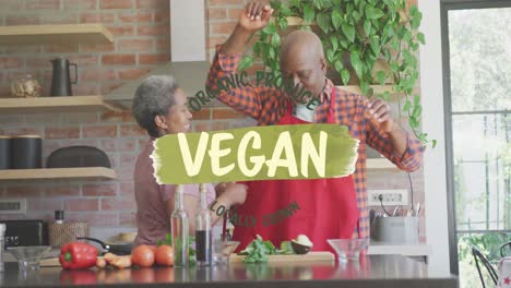 Animation-of-vegan-food-text-over-african-american-couple-preparing-veggies-in-kitchen