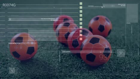 Animation-of-interface-with-data-processing-against-close-up-of-footballs-on-grass-field