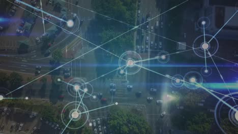 Animation-of-dots-connected-with-lines-over-aerial-view-of-vehicles-and-buildings