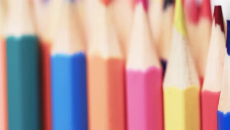 Close-up-of-sharpened-multi-coloured-pencils-with-copy-space-on-white-background