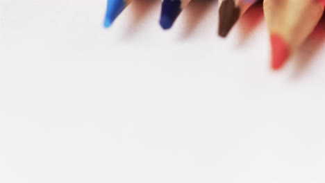 Close-up-of-sharpened-multi-coloured-pencils-with-copy-space-on-white-background