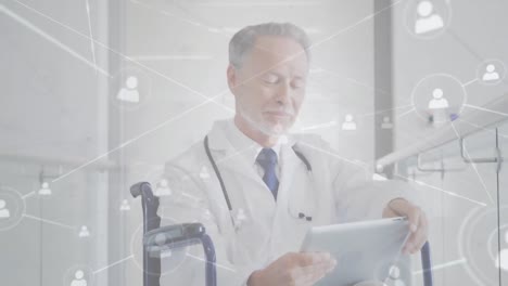 Animation-of-network-of-connections-with-icons-over-caucasian-male-doctor-using-tablet-in-wheelchair