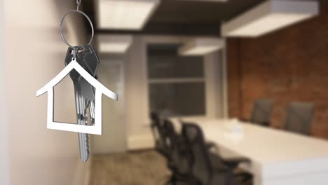 Animation-of-hanging-silver-house-keys-against-interior-of-a-office-conference-room