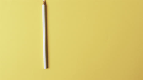 Close-up-of-yellow-pencil-with-copy-space-on-yellow-background
