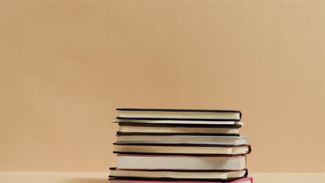 Close-up-of-stack-of-books-with-copy-space-on-yellow-background