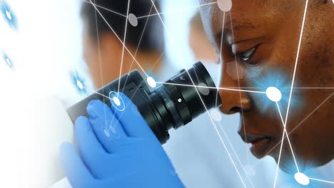 Animation-of-network-of-connections-over-african-american-female-scientist-using-microscope
