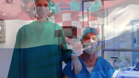 Animation-of-waving-croatia-flag-over-portrait-of-caucasian-male-and-female-surgeons-at-hospital