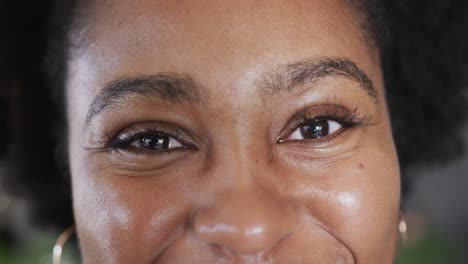 Nahaufnahme-Eines-Porträts-Der-Augen-Einer-Glücklichen-Afroamerikanischen-Frau,-Die-Lächelt,-In-Zeitlupe