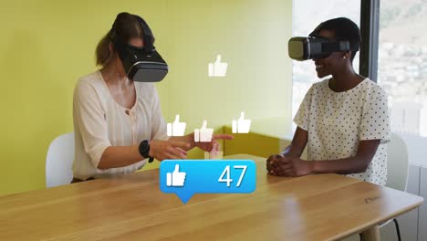 Animation-of-like-icon-with-increasing-numbers-over-two-diverse-women-wearing-vr-headsets-at-office