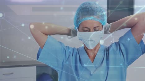 Animation-of-data-processing-over-caucasian-female-surgeon-in-face-mask