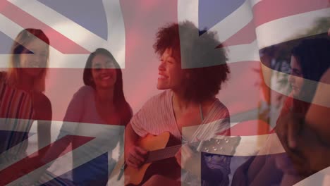 Animation-of-diverse-friends-at-beach-party-over-flag-of-great-britain