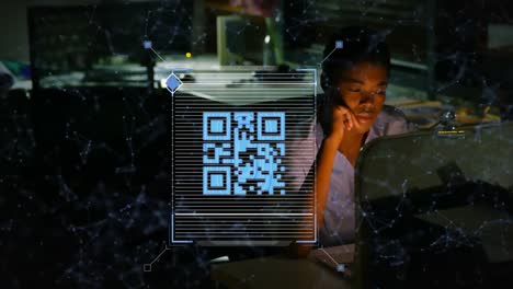 Animation-of-qr-data-processing-over-african-american-businesswoman-with-computer-in-office