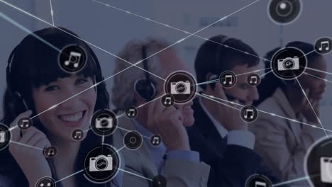 Animation-of-network-of-digital-icons-over-diverse-business-people-talking-on-phone-headsets