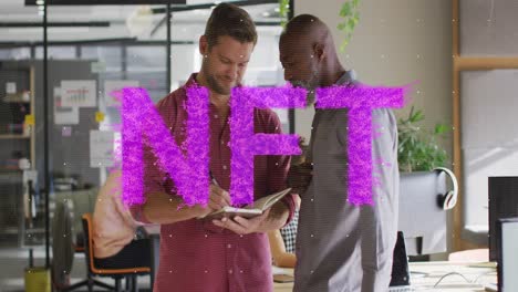 Animation-of-purple-nft-text-banner-against-two-diverse-men-discussing-at-office